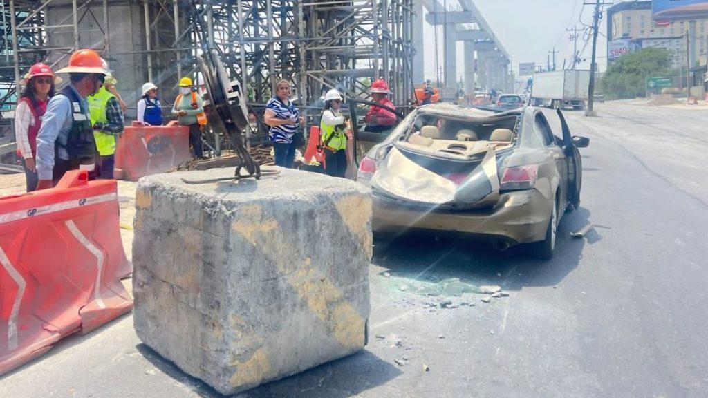 Collision Scene on a City Street: a Badly Damaged Beige Sedan with Broken Rear, Surrounded by Construction Workers in Hard Hats and Orange Barriers Nearby. - Glen Facturero