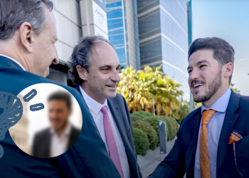 Three Businessmen in Suits Greet Each Other Outside a Modern Glass-front Building; a Circular Blurred Inset of Another Man Overlaps the Scene. - Glen Facturero