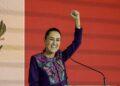 Woman in a Purple Floral Blazer Raises Her Fist While Speaking at a Podium on Stage. - Glen Facturero