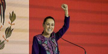 Woman in a Purple Floral Blazer Raises Her Fist While Speaking at a Podium on Stage. - Glen Facturero