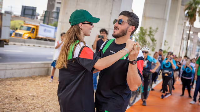 a Man and Woman Dance Together Outdoors at a Street Event, with a Crowd Watching in the Background and a Yellow Truck Visible Nearby. - Glen Facturero