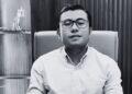 Man Wearing Glasses Sits in an Office Chair, Facing the Camera. - Glen Facturero