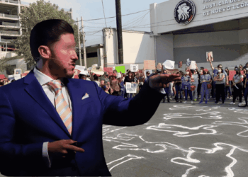 a Man in a Blue Suit Gestures Toward a Crowd of Protesters Holding Signs, with Chalk Outlines on the Pavement Behind Them Near a Justice Building. - Glen Facturero